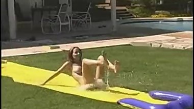 Tawnee Stone sliding fun in the garden with friends