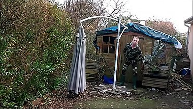 vintage - smoking guy in camo and rubber boots undressing