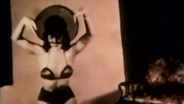 Brunette Witch Entices Audience in Lingerie (1950s Vintage)