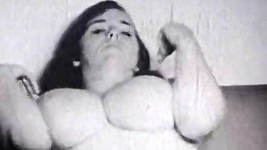 Brunette with very Big Tits Teases Herself